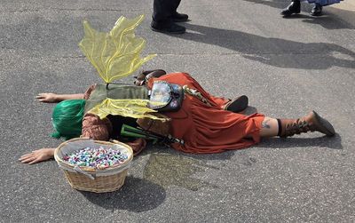 A tired Teak laying facedown on the road